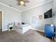 Well-lit bedroom with a flat-screen television and comfortable furnishings at 13013 County Road 561A, Clermont, FL 34715