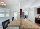 Bright breakfast nook with modern windows, granite breakfast bar, and outdoor access at 13013 County Road 561A, Clermont, FL 34715
