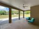 Covered patio with comfortable seating and a ceiling fan for outdoor relaxation at 13013 County Road 561A, Clermont, FL 34715