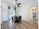 Dining room featuring wood-look tile floors, a ceiling fan, and sliding glass doors to the lanai at 13013 County Road 561A, Clermont, FL 34715