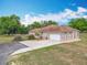 Charming home with a well-manicured lawn and a three car attached garage at 13013 County Road 561A, Clermont, FL 34715