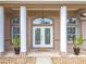 Detailed view of the front door, showcasing its decorative glass and elegant hardware at 13013 County Road 561A, Clermont, FL 34715