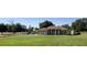 A single-story home boasts a sprawling lawn, complemented by mature trees, and a columned entryway at 13013 County Road 561A, Clermont, FL 34715
