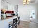 Open concept kitchen featuring a breakfast bar, dark wood cabinets, and granite countertops at 13013 County Road 561A, Clermont, FL 34715