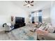 Bright living room with a large TV, comfortable seating, and neutral decor at 13013 County Road 561A, Clermont, FL 34715