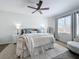 Well-lit main bedroom with a ceiling fan and cozy seating area at 13013 County Road 561A, Clermont, FL 34715