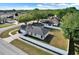Aerial view of the home showing the backyard, white fencing, and the surrounding neighborhood at 1313 Lake Idamere Blvd, Tavares, FL 32778