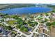 An aerial view of homes nestled near a serene lake, surrounded by lush greenery and open spaces at 1313 Lake Idamere Blvd, Tavares, FL 32778