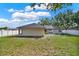 This backyard features a big, well-maintained lawn and is enclosed by a white vinyl fence at 1313 Lake Idamere Blvd, Tavares, FL 32778