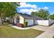 Charming single-story home featuring a well-manicured lawn and an attached two-car garage at 1313 Lake Idamere Blvd, Tavares, FL 32778