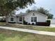 Charming one-story home featuring well-maintained landscaping and a welcoming entrance at 1313 Lake Idamere Blvd, Tavares, FL 32778