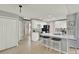 Bright kitchen features white cabinets, stainless appliances, and a breakfast bar with seating at 1313 Lake Idamere Blvd, Tavares, FL 32778
