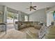Cozy living room featuring neutral paint, a ceiling fan, and sliding doors to the backyard at 1313 Lake Idamere Blvd, Tavares, FL 32778