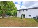The backyard features a newly built two-story home with green grass at 1336 Crystal Lake E Ave, Orlando, FL 32806