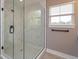 Elegant shower with marble-patterned walls and glass door, offering a spa-like experience at 1336 Crystal Lake E Ave, Orlando, FL 32806