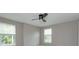 This bedroom features a ceiling fan, two windows and neutral paint at 1336 Crystal Lake E Ave, Orlando, FL 32806