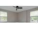 Spacious bedroom showcasing wood floors and neutral colors, with ample natural light from a large window at 1336 Crystal Lake E Ave, Orlando, FL 32806