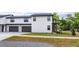 Modern townhome exterior featuring a two-car garage and sleek design with black trim at 1336 Crystal Lake E Ave, Orlando, FL 32806