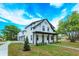 Beautiful two-story white home with black trim, manicured lawn, and inviting front porch at 1336 Crystal Lake E Ave, Orlando, FL 32806