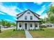 Charming two-story white house with a welcoming front porch and well-maintained lawn at 1336 Crystal Lake E Ave, Orlando, FL 32806