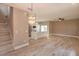 Open-concept living room and kitchen area with hardwood floors and modern lighting at 1336 Crystal Lake E Ave, Orlando, FL 32806