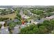 Houses with mature landscaping and lawns with nearby body of water in the distance at 135 Crepe Myrtle Dr, Groveland, FL 34736