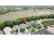 Aerial view shows houses with large yards, lots of trees and green space in the distance at 135 Crepe Myrtle Dr, Groveland, FL 34736
