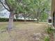 View of lush backyard with mature trees and landscaping at 135 Crepe Myrtle Dr, Groveland, FL 34736