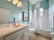 Bathroom featuring a combined bath and shower, stylish vanity, and a framed mirror at 135 Crepe Myrtle Dr, Groveland, FL 34736