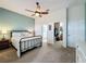 This bedroom features a ceiling fan, an attached bathroom and a walk-in closet at 135 Crepe Myrtle Dr, Groveland, FL 34736