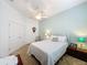 Inviting bedroom with ceiling fan, ample closet space, and a white iron bedframe at 135 Crepe Myrtle Dr, Groveland, FL 34736