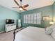 This bedroom features a ceiling fan, shuttered windows and carpet flooring at 135 Crepe Myrtle Dr, Groveland, FL 34736