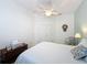 Bedroom featuring a ceiling fan, side table, and closet with double doors at 135 Crepe Myrtle Dr, Groveland, FL 34736