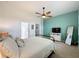 This bedroom features a ceiling fan and adjacent bathroom and closet at 135 Crepe Myrtle Dr, Groveland, FL 34736