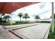 Outdoor bocce ball court area with beautiful landscaping and relaxing atmosphere at 135 Crepe Myrtle Dr, Groveland, FL 34736