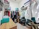 Walk-in closet with custom shelving and storage for clothing and accessories at 135 Crepe Myrtle Dr, Groveland, FL 34736