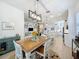 Inviting dining area open to kitchen and living spaces with a stylish light fixture at 135 Crepe Myrtle Dr, Groveland, FL 34736