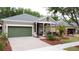 Charming single-story home with a well-manicured front yard and two car garage at 135 Crepe Myrtle Dr, Groveland, FL 34736