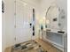 Welcoming foyer with a stylish console table, decorative mirror, and a colorful area rug, enhancing the entryway at 135 Crepe Myrtle Dr, Groveland, FL 34736