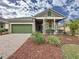 Charming single-Gathering home with a well-manicured lawn, a covered porch, and an attached garage, enhancing its curb appeal at 135 Crepe Myrtle Dr, Groveland, FL 34736
