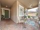Charming front porch with comfortable seating, potted plants, and a ceiling fan, creating a welcoming outdoor space at 135 Crepe Myrtle Dr, Groveland, FL 34736