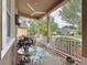 Inviting front porch featuring cozy furniture, floral arrangements, and a ceiling fan for ultimate relaxation at 135 Crepe Myrtle Dr, Groveland, FL 34736
