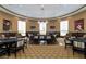 Upscale game room with poker tables, lounge seating, TVs, and elegant lighting fixtures at 135 Crepe Myrtle Dr, Groveland, FL 34736