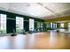 Brightly lit gym with exercise bikes, large windows, and mirrored wall for a modern fitness experience at 135 Crepe Myrtle Dr, Groveland, FL 34736