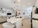 Open concept kitchen and living room featuring a large island and modern design at 135 Crepe Myrtle Dr, Groveland, FL 34736