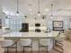 Bright and modern kitchen with white cabinets, a large island, and stainless steel appliances at 135 Crepe Myrtle Dr, Groveland, FL 34736