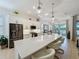 Modern kitchen with white cabinetry, stainless steel appliances, and a large island with seating at 135 Crepe Myrtle Dr, Groveland, FL 34736