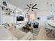 Open-concept living room with built-in shelving, comfortable seating, and a ceiling fan, perfect for entertaining at 135 Crepe Myrtle Dr, Groveland, FL 34736