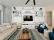 Bright living room featuring a built-in entertainment center and modern furnishings at 135 Crepe Myrtle Dr, Groveland, FL 34736