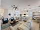 Spacious living room with tile floors, comfortable seating, and a view of the open kitchen, ideal for modern living at 135 Crepe Myrtle Dr, Groveland, FL 34736